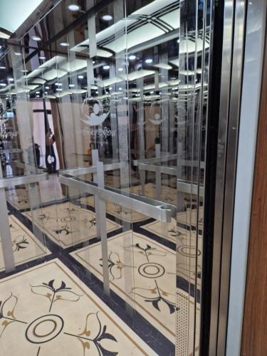 a glass display case in a store with a tile floor at INJU апартаменты in Taldykolʼ