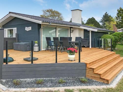 a wooden deck in front of a house at Holiday Home Eddy - all inclusive - 50m from the sea by Interhome in Kragenæs