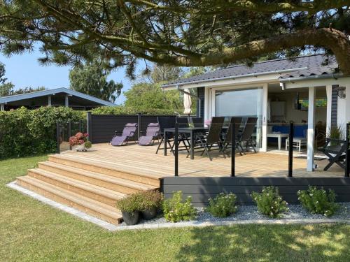 a deck with chairs and a table on a house at Holiday Home Eddy - all inclusive - 50m from the sea by Interhome in Kragenæs