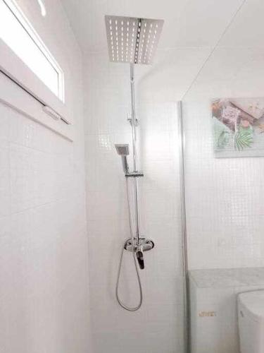 a shower in a white bathroom with a toilet at * * Costa Guacimeta * * Apartment in Los Pocillos