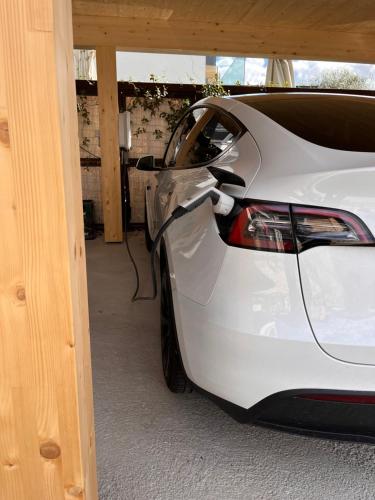 a white car is parked in a garage at Hotel Raffl in Bolzano