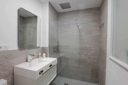 a white bathroom with a sink and a shower at ARQ Home Arrecife in Arrecife