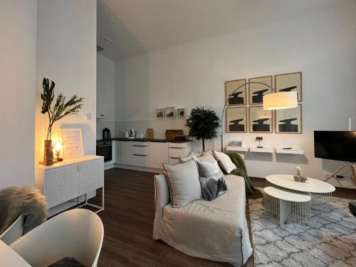 a living room with a couch and a table at Lunas Appartements in der alten Schule Essen in Essen