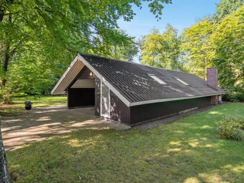 an old barn with a garage in a yard at Holiday Home Jaakoppi - 25km from the sea by Interhome in Toftlund