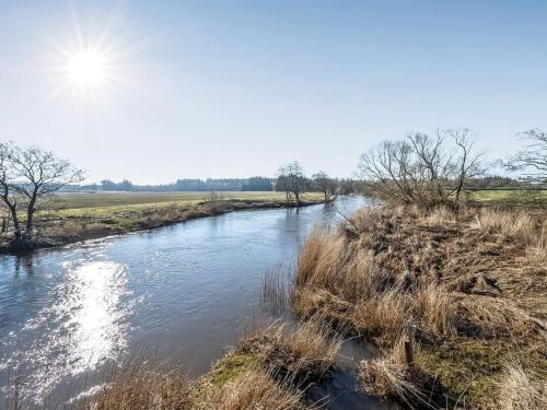 a river in a field with the sun in the sky at Apartment Gertraude - 17km to the inlet in Western Jutland by Interhome in Skjern