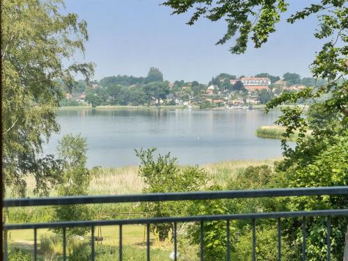 a view of a lake from a balcony at Holiday Home Harka - 100m to the inlet in Sealand by Interhome in Roskilde