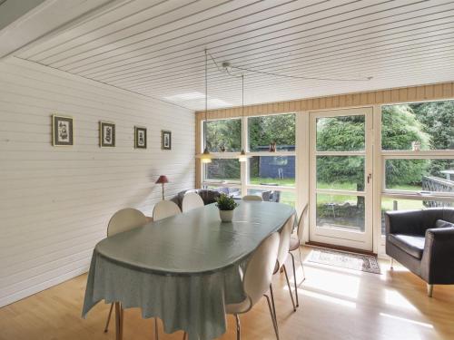 a dining room with a table and chairs at Holiday Home Pinja - 40km from the sea in SE Jutland by Interhome in Silkeborg