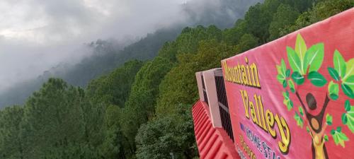 a train traveling through a lush green forest at Mountain green valley homestay in Lansdowne