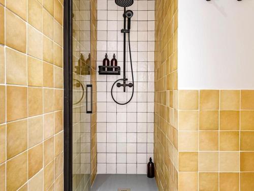 a shower in a bathroom with a tile wall at Spacious apartment in the Gothic in Barcelona