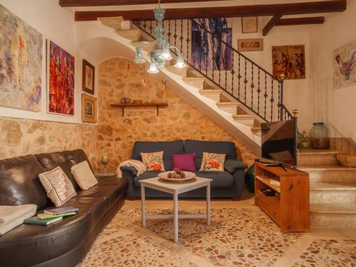 a living room with a couch and a staircase at Holiday Home Can Salom by Interhome in Binissalem