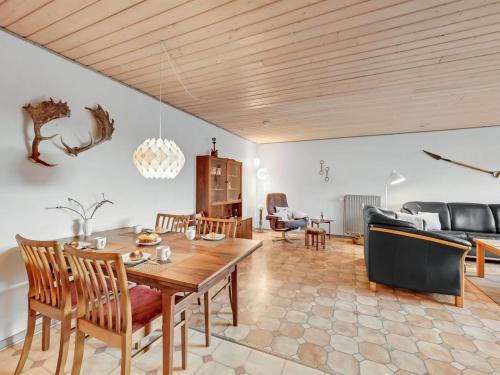 a living room with a wooden table and a couch at Apartment Evina - 17km to the inlet by Interhome in Skjern