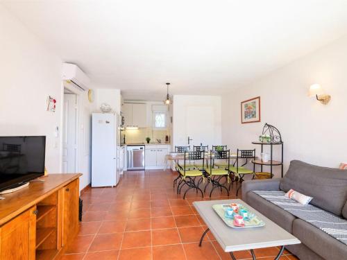 un salon avec un canapé et une table dans l'établissement Apartment Le Domaine de Figuière-2 by Interhome, à Sainte-Maxime