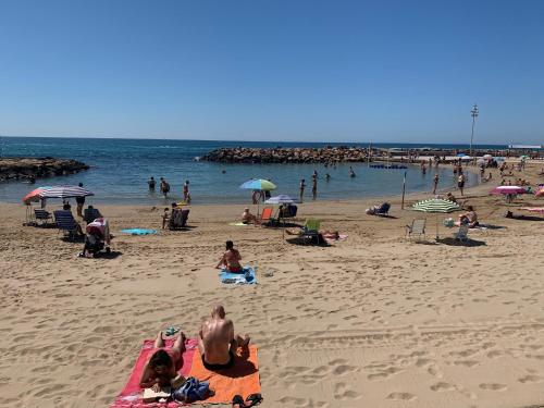 a group of people on a beach with the ocean at Casa Tierra Torrievieja close to the beach Playa del Cura in Torrevieja
