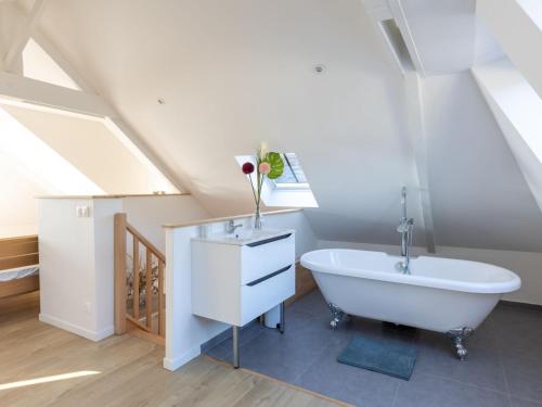 a bathroom with a sink and a bath tub at Apartment Vue Eméraude by Interhome in Cancale