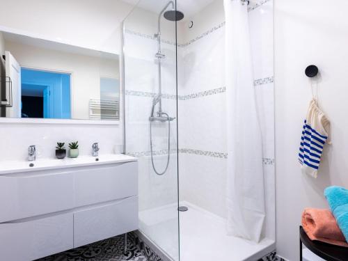a white bathroom with a shower and a sink at Apartment Vue Eméraude by Interhome in Cancale