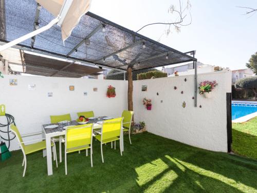 a patio with a table and chairs and a pool at Villa Villa Casalot 9 by Interhome in Miami Platja