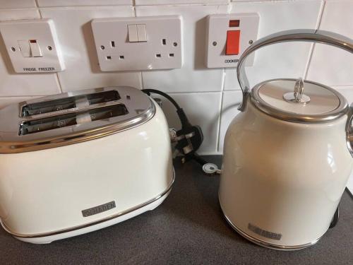 a toaster and a tea kettle sitting on a counter at Cosy apartment near Newcastle in Gateshead