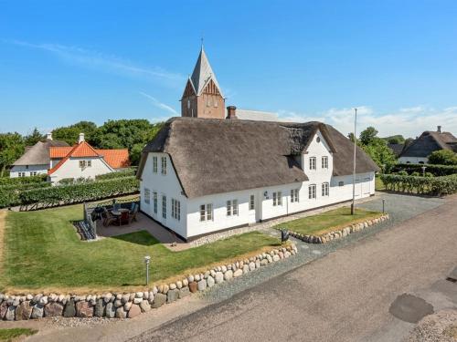 a large white church with a steeple on top of it at Holiday Home Ejna by Interhome in Bredebro