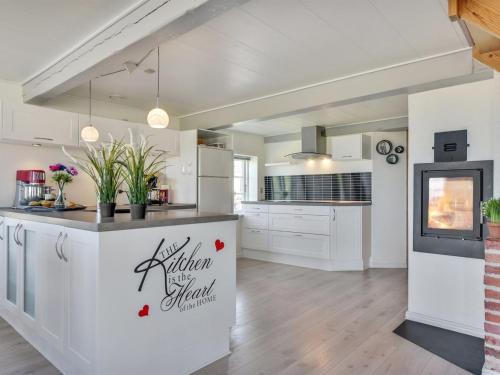 a kitchen with white cabinets and a counter with plants at Holiday Home Ejna by Interhome in Bredebro