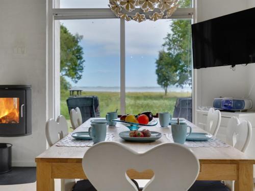 a dining room with a table with a heart shaped chair at Holiday Home Ødger - 150m to the inlet in The Liim Fiord by Interhome in Åbybro