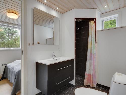a bathroom with a sink and a shower at Holiday Home Ødger - 150m to the inlet by Interhome in Åbybro