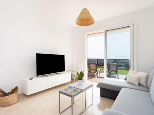 A television and/or entertainment centre at Apartment Playa Negra II by Interhome