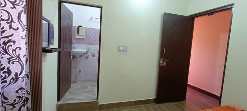 a bathroom with a toilet and a sink and a mirror at Mountain green valley homestay in Lansdowne