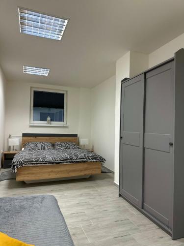 a bedroom with a bed and a television in it at Apartmán Pantáreň in Stará Bystrica