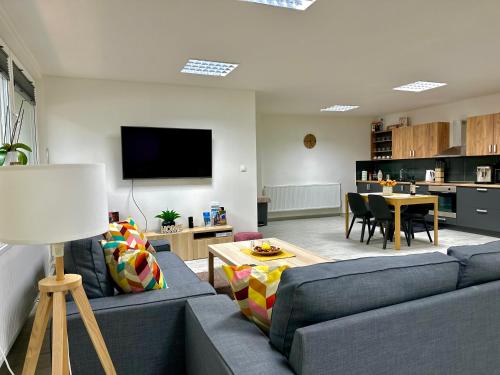 a living room with a blue couch and a table at Apartmán Pantáreň in Čadca