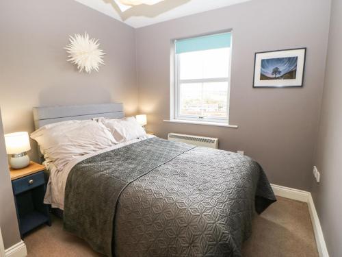 a bedroom with a bed and a window at 4 Alpha Rise in Brampton