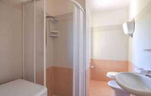 a bathroom with a shower and a toilet and a sink at Villa Maria Carmela in Briatico