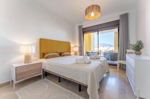 a bedroom with a large bed and a large window at CT 199 - Duquesa Village in Manilva
