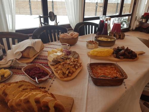 a table with many different types of food on it at Șura lu' Vasile. in Crivina