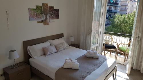 a bedroom with a bed with two white shoes on it at Il Nido di Pikki in Falconara Marittima