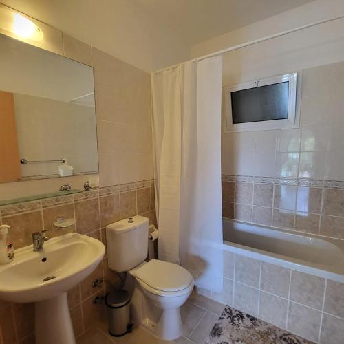 a bathroom with a toilet and a sink and a tub at SUMMER TERRACE 26 in Kalecik