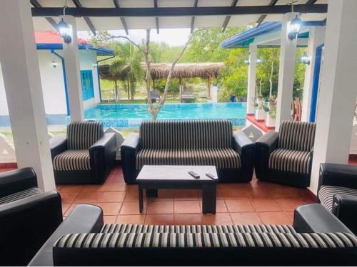 a lobby with couches and a table and a pool at Seth Villa by Magampura Resorts in Tangalle