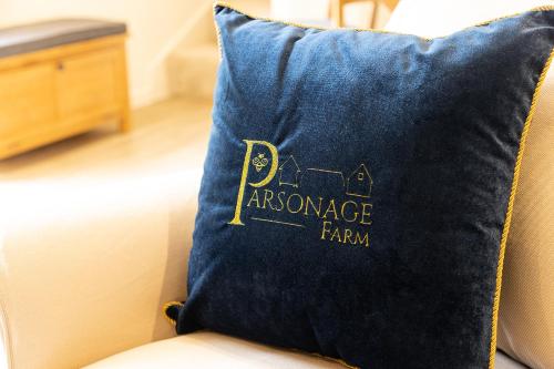 a blue pillow with the words insurance farm on it at The Stable in Canterbury