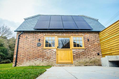 a house with solar panels on top of it at The Stable in Canterbury