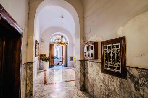 an empty hallway with a chandelier in a building at Daniel's Apartment in Bari