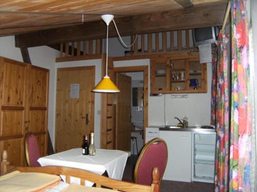 a kitchen and dining room with a table and chairs at Gassermühle-Ferienhaus in Eggen