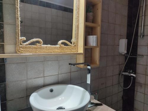 a bathroom with a sink and a mirror at Golden Sky 1 Apartment in Perea