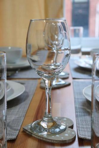 a wine glass sitting on top of a table at Peaceful 2 Bed House FREE WiFi and Parking in Belle Isle