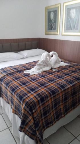 a hotel room with a bed with towels on it at One Hotel in João Pessoa
