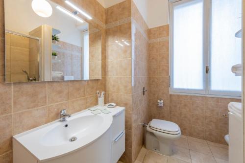a bathroom with a tub and a toilet and a sink at Milan Royal Suites - Centro in Milan