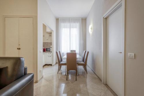 a dining room with a table and chairs at Milan Royal Suites - Centro in Milan