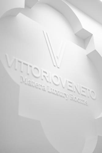 a logo for a warehouse inventory room at Vittorio Veneto Matera Luxury Rooms in Matera