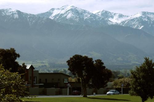 a mountain range with snow capped mountains in the distance at Kaikoura Gateway Motor Lodge in Kaikoura