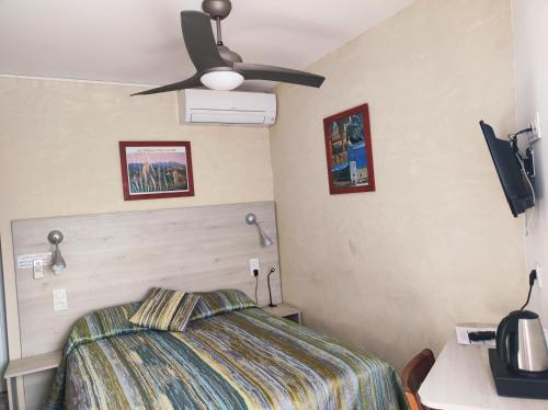 a bedroom with a bed and a ceiling fan at Auberge du Bon Vivant in Argelès-sur-Mer