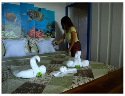 a woman is making swans on a bed at Terrazas del Golfo in La Palma