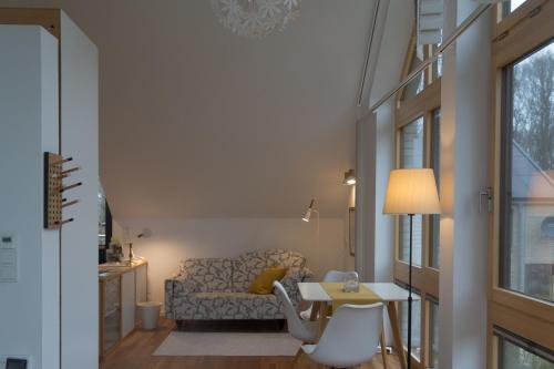 a living room with a couch and a table at Ferienhaus Schleiharmonie in Ulsnis
